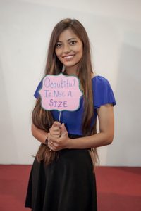 A girl holding a sign.