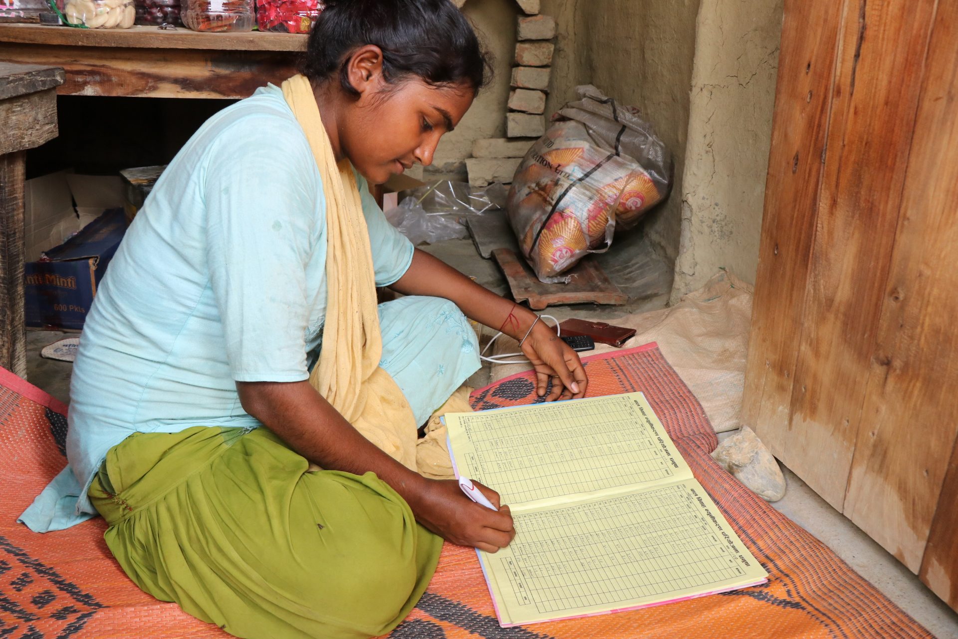 Prativa filling in her bookkeeping book.