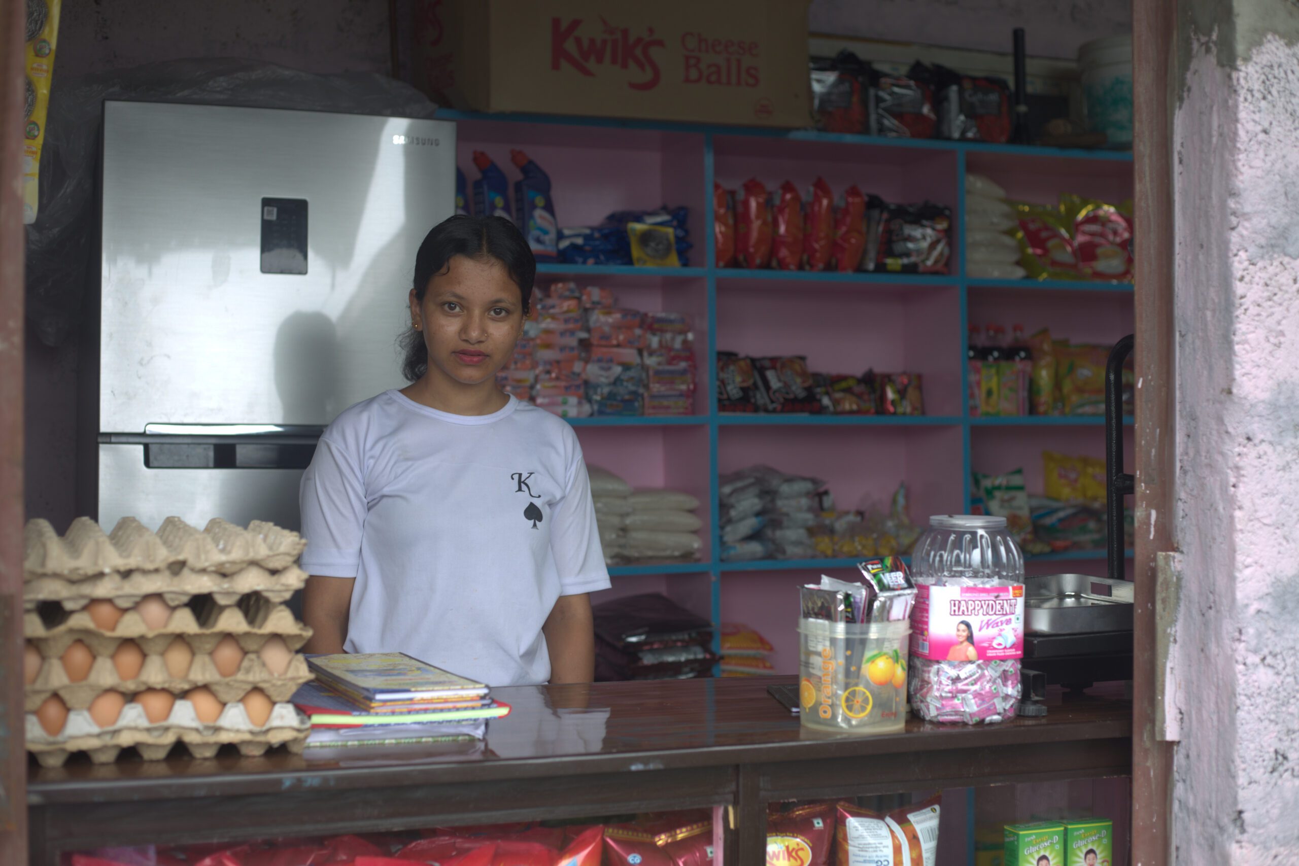 Dhanmaya standing inside her grocery shop.