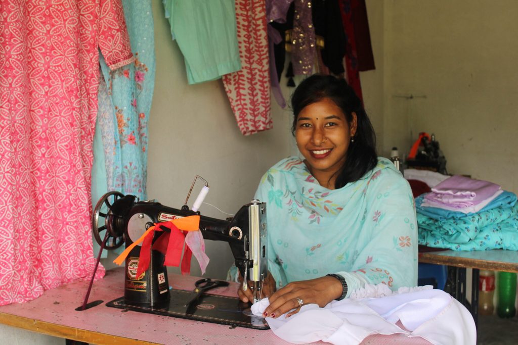 Rishmani is using her sewing machine to make the clothes. 