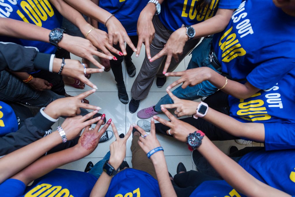 Girls making stars with their hands.