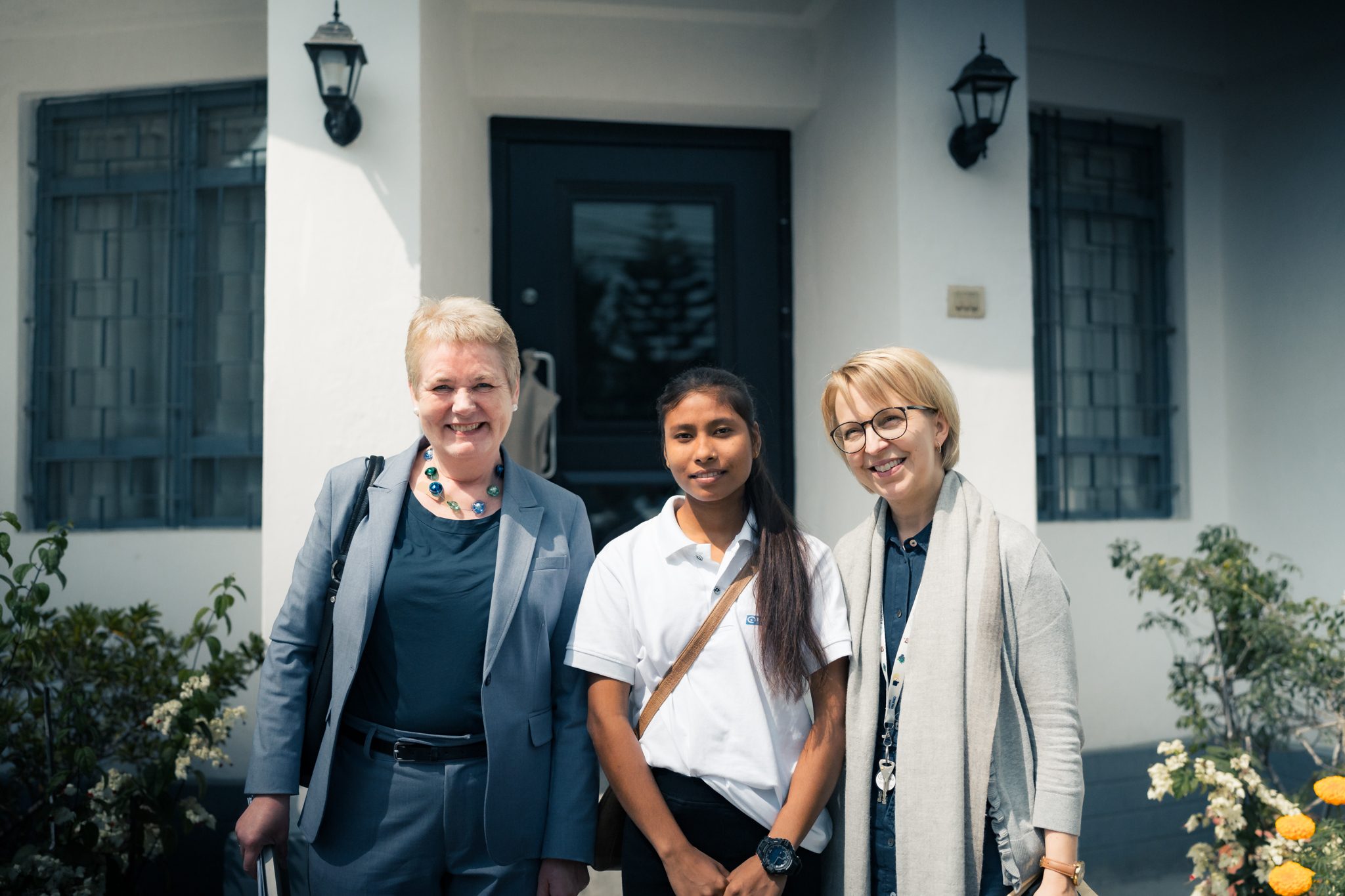Sangita is posing in front of Finnish Embassy with ambassadors of Norway (on her right) and Finland (on her left). 