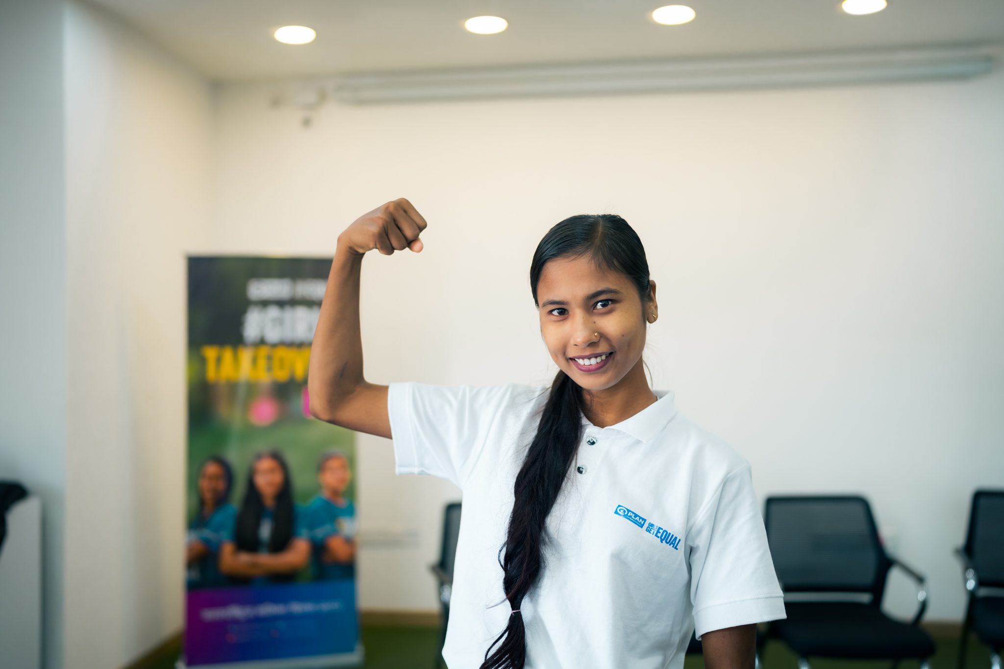 Akriti is raising her arms and posing stronger in front of camera. 