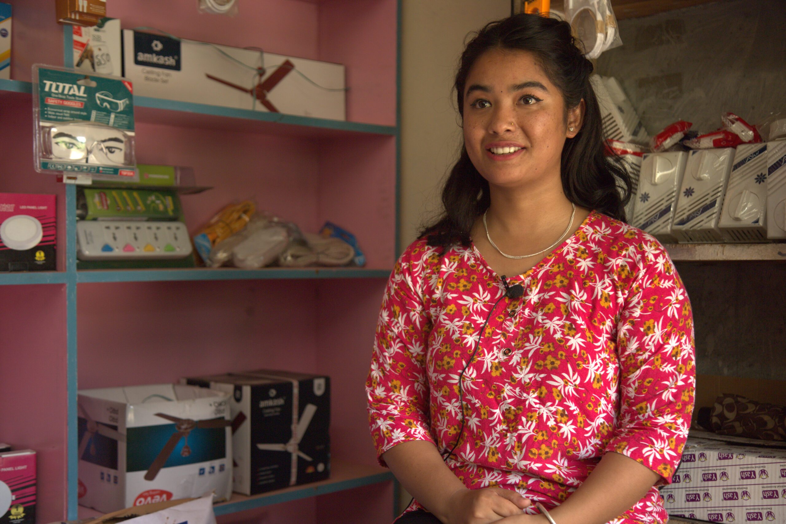 Bipana is sitting inside her electrical shop.