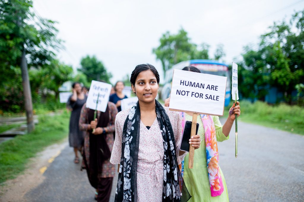 A girl holding a placard on anti human trafficking campaign message.