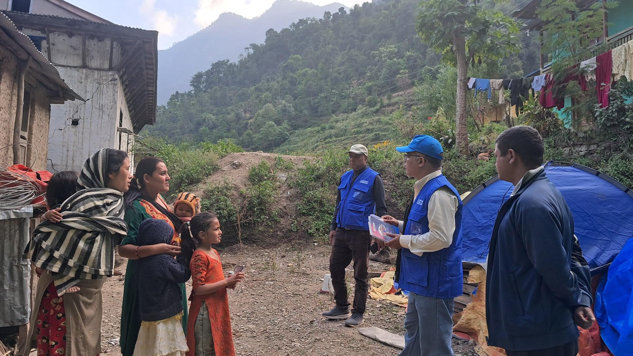Plan International staff interacting with earthquake affected people in Jajarkot.