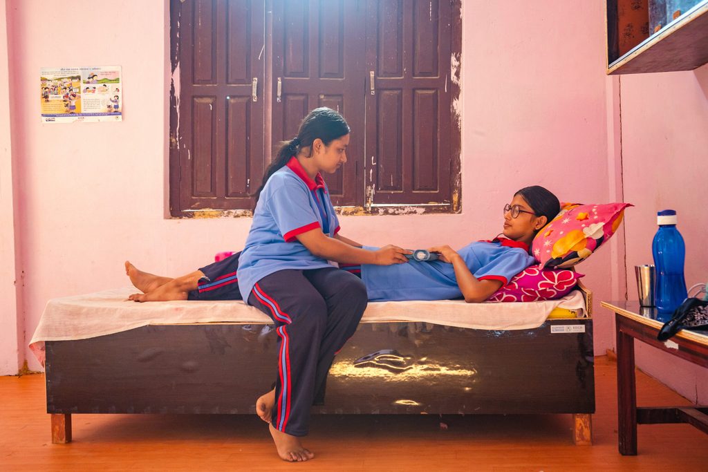 Adolescent girls using menstrual health management restroom in their school.