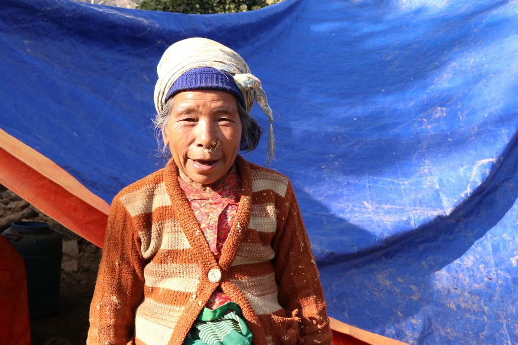 Birvi standing in front of tarps and smiling.