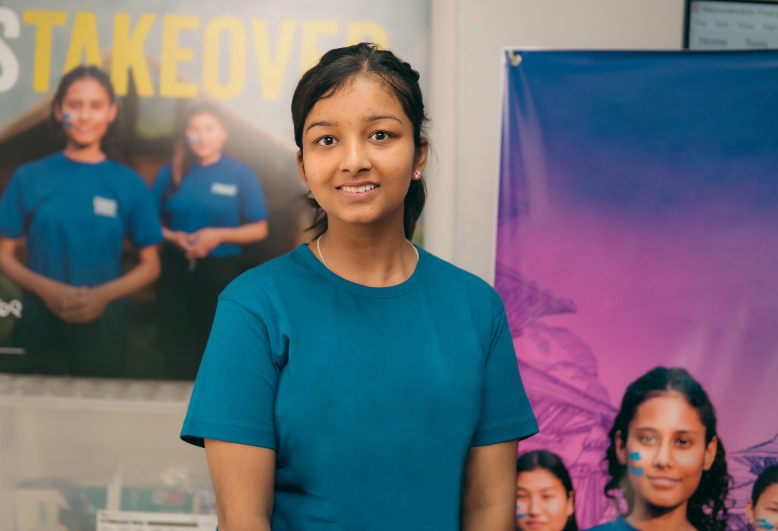 A young campaigner Samikshya posing for a photo wearing blue t-shirt and smiling. 