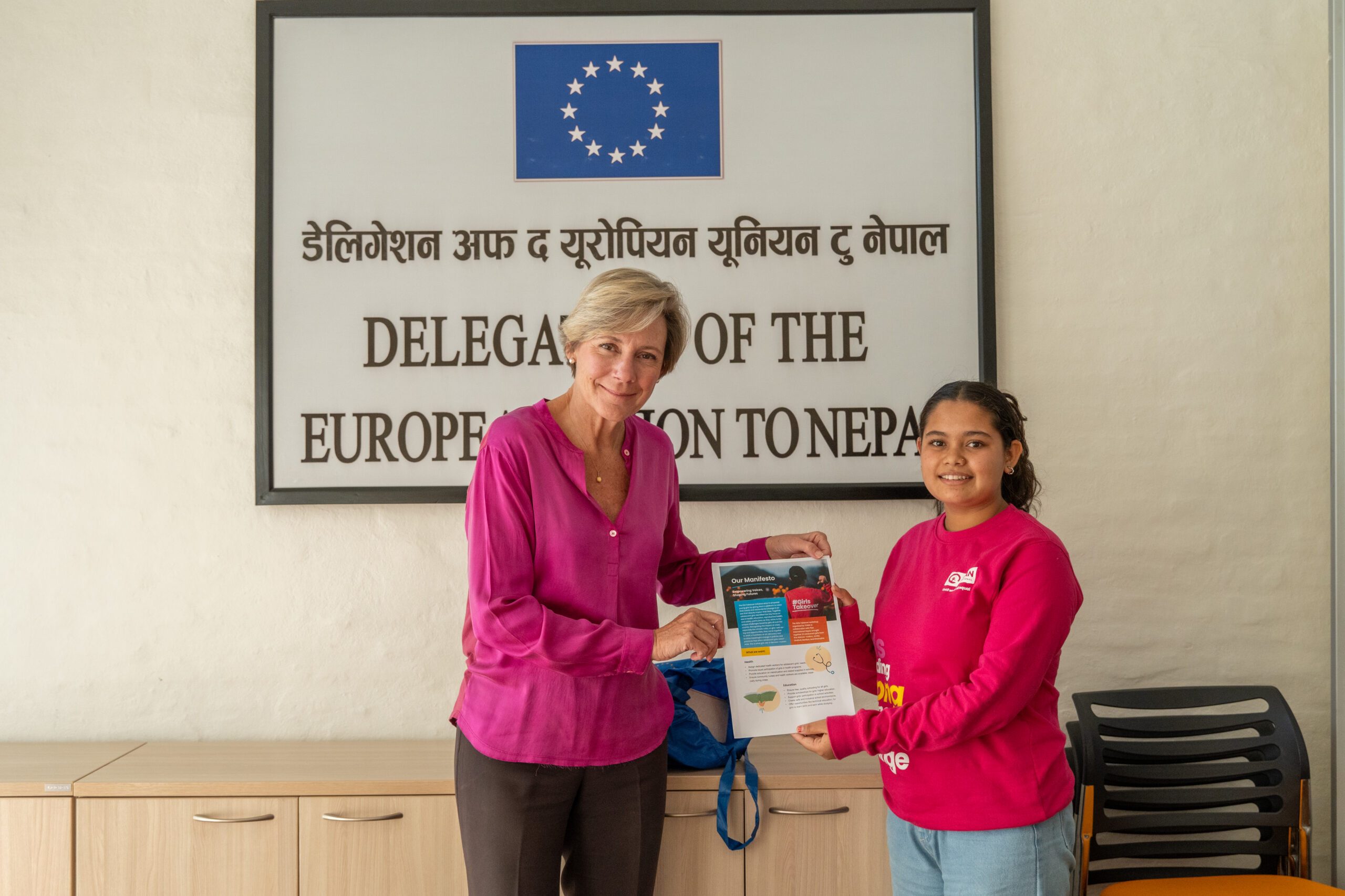 Ranjita on right handing over Girls' Manifesto to H.E. Veronique on left.