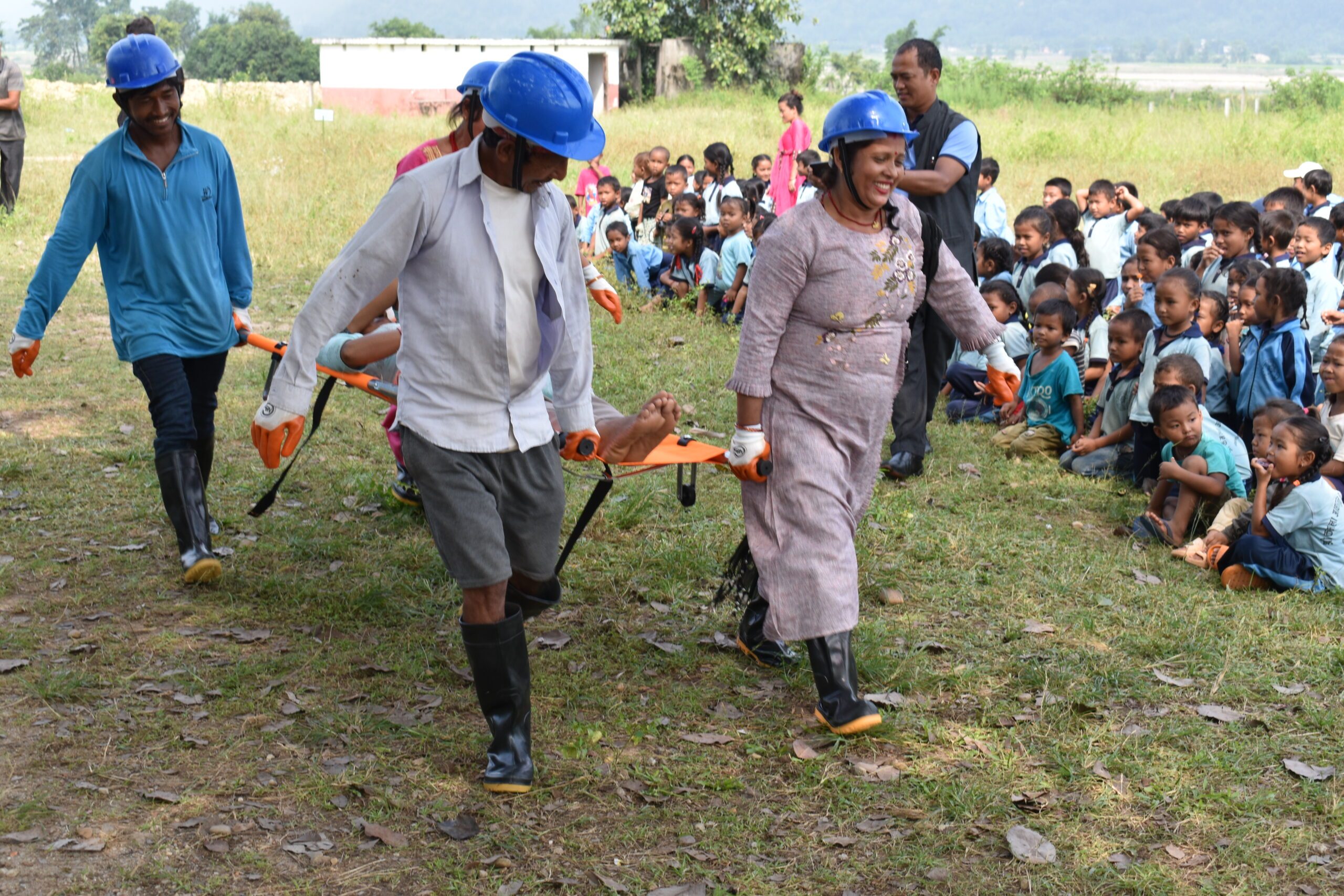 Students are observing the mock drill training happening in their school.