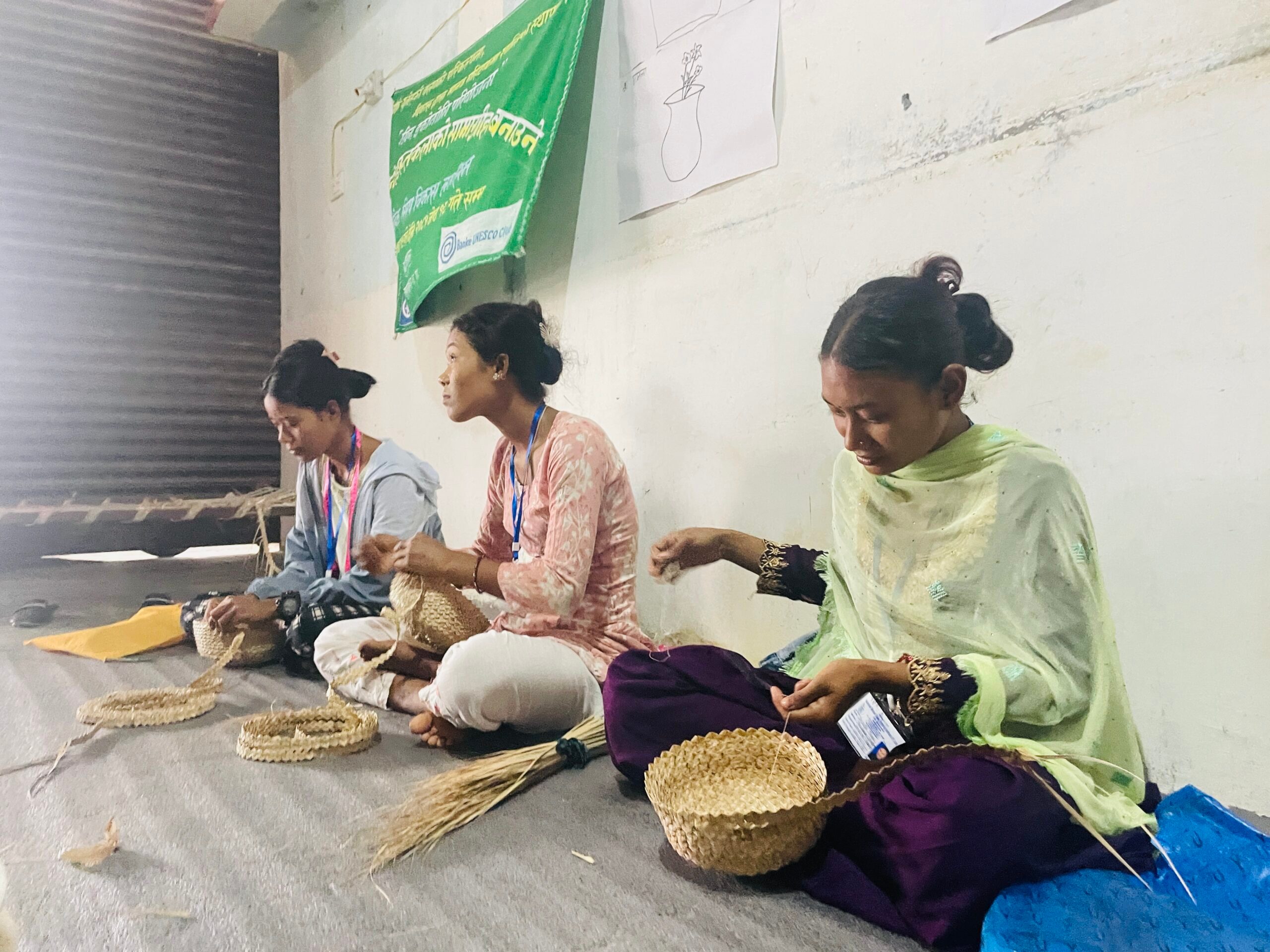 Three young women making handicrafts.