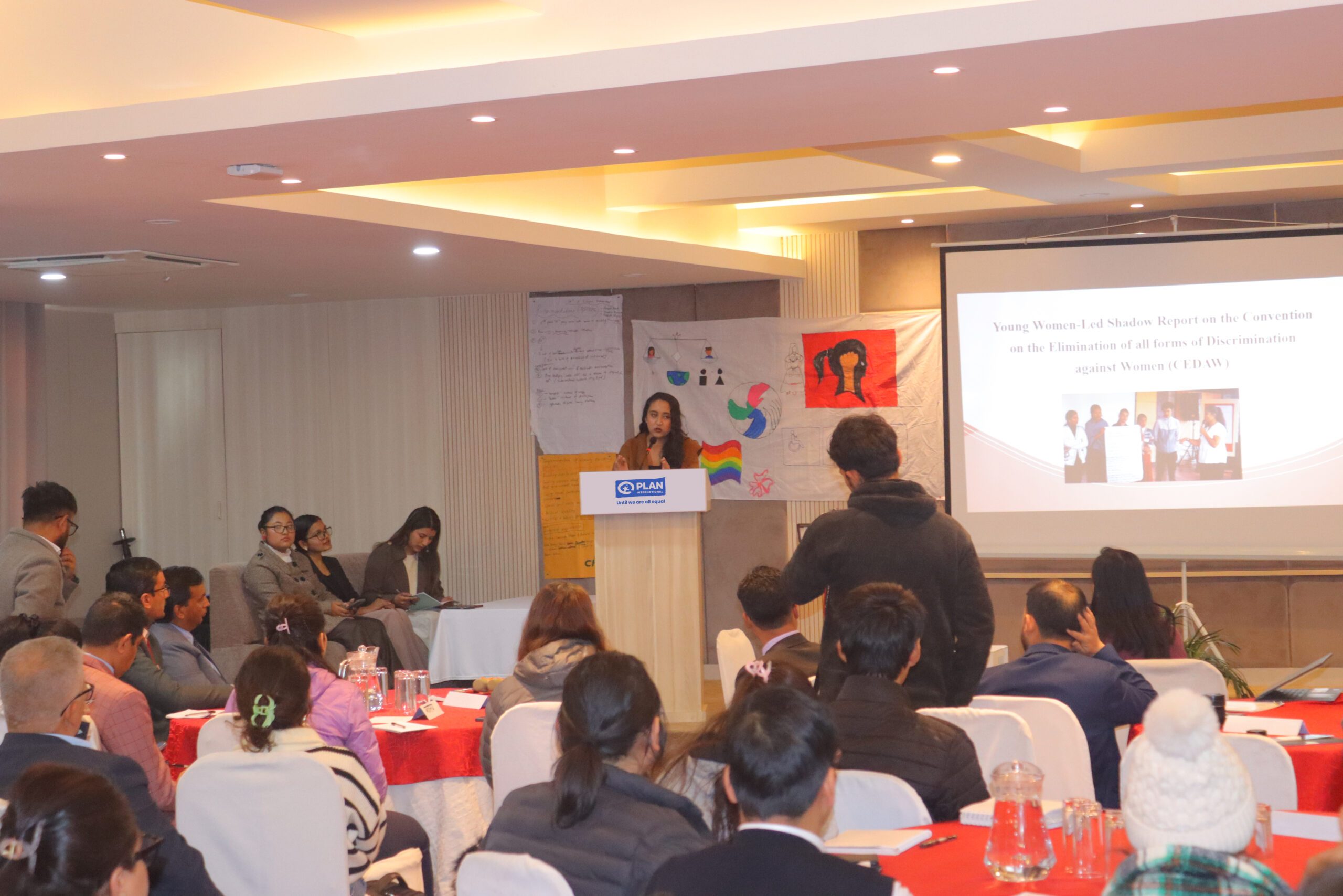 A young woman sharing her experience from field to a group of young people.