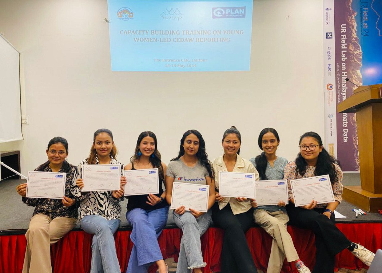 Seven young women are siting and holding certificates