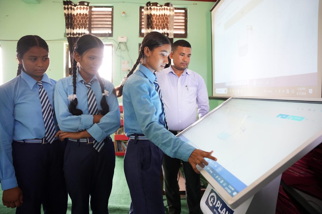 Students learning using kiosk in school.