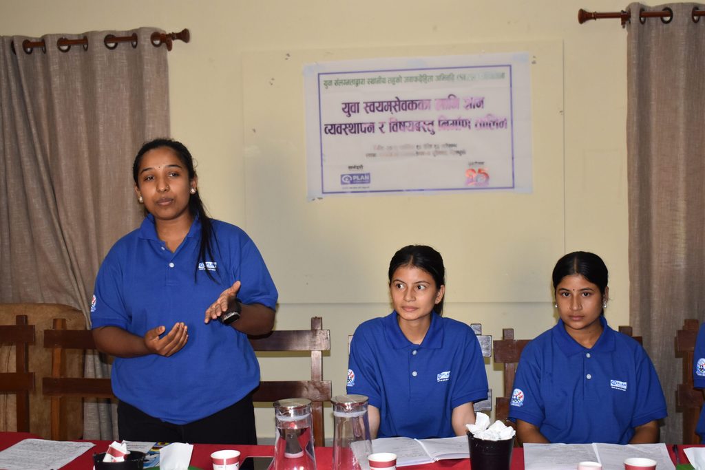 Three girls wearing blue t-shirt attending a training