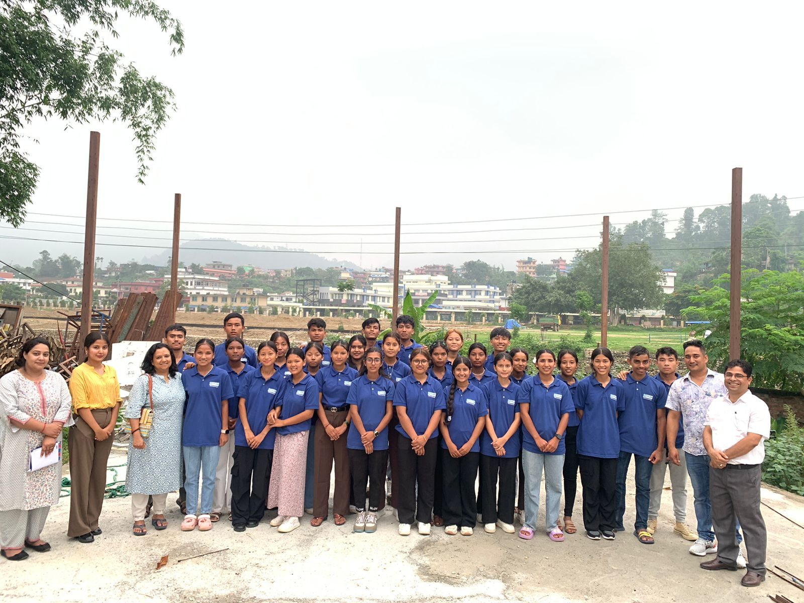 A group of young people getting ready for group photo.