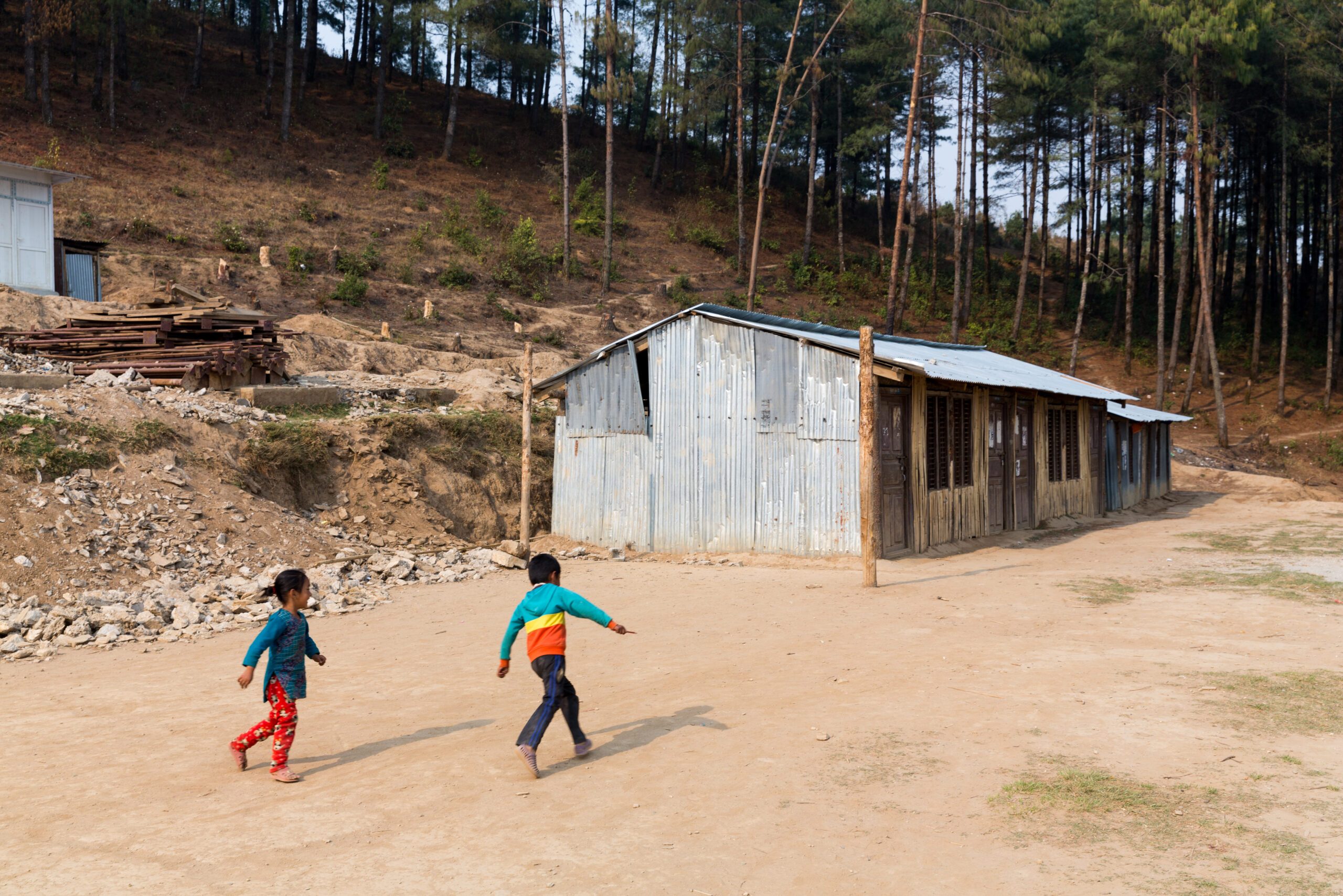 Two children playing in front of the safe learning spaces.