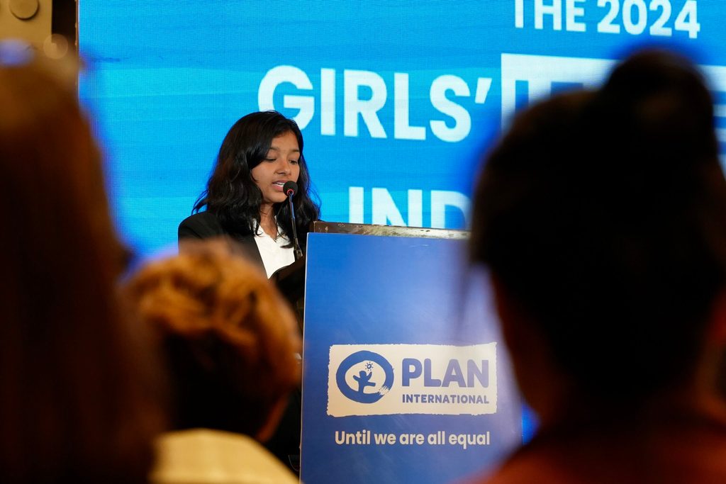 A young campaigner Samikshya speaking on the stage in front of the crowd