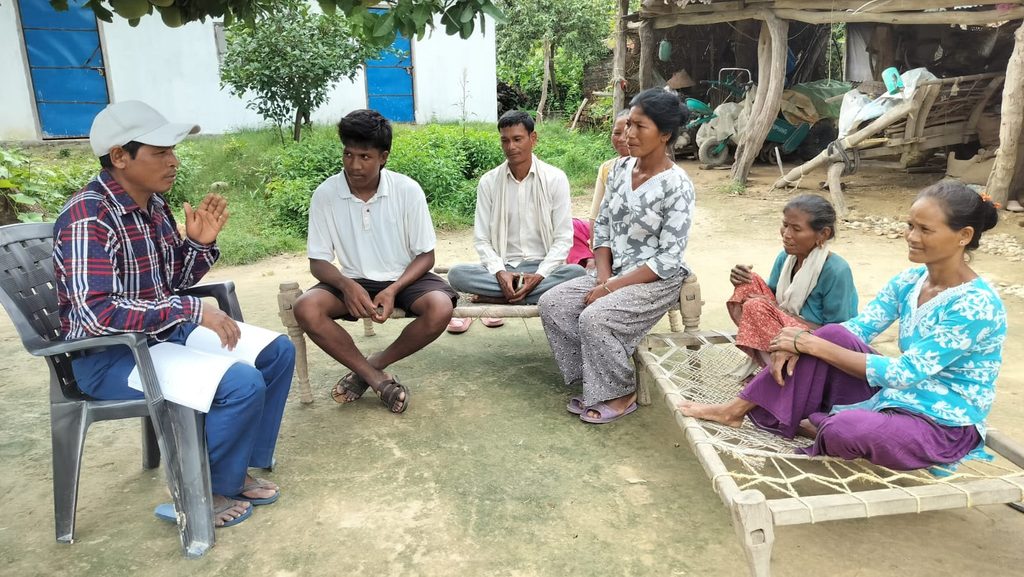Kaluram sharing what he has learned about adolescent sexual and reproductive health and rights with his neighbours.