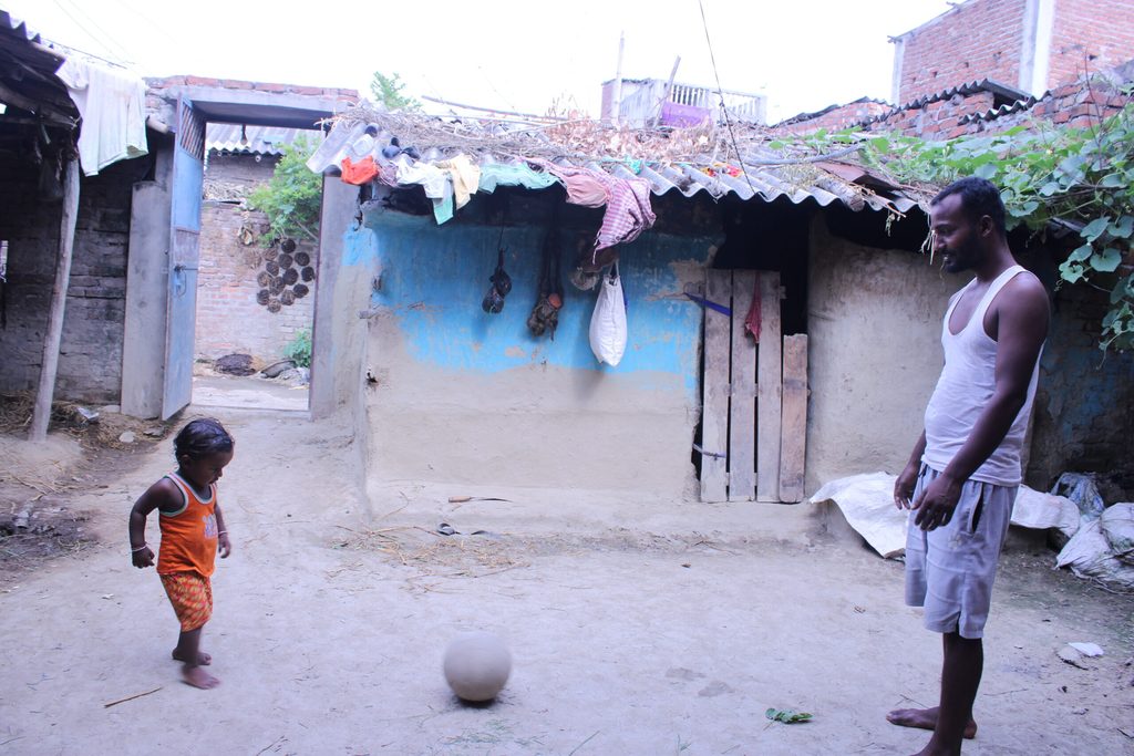 Tarani, a father playing a ball with his child in their house.