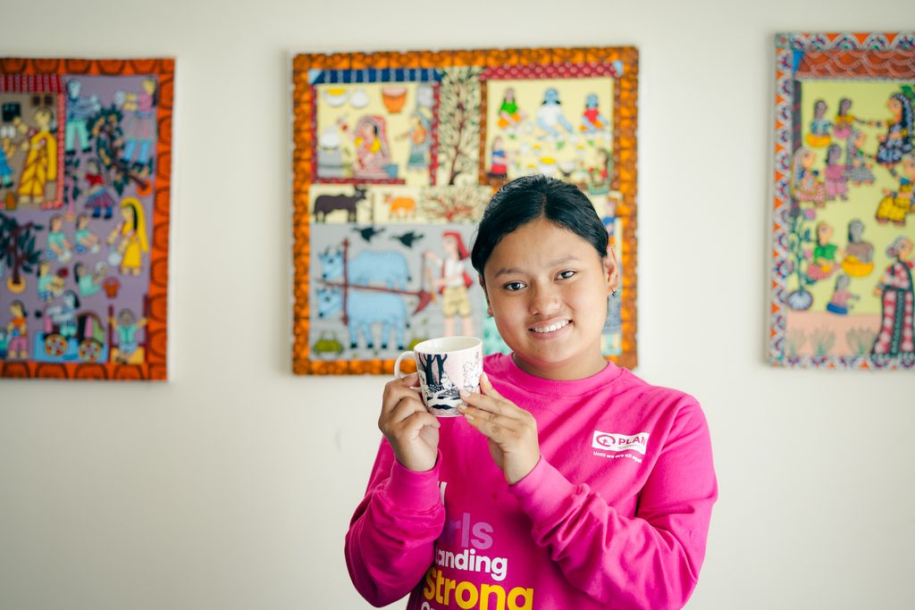 Ramila holding the cup with Moomin imprint