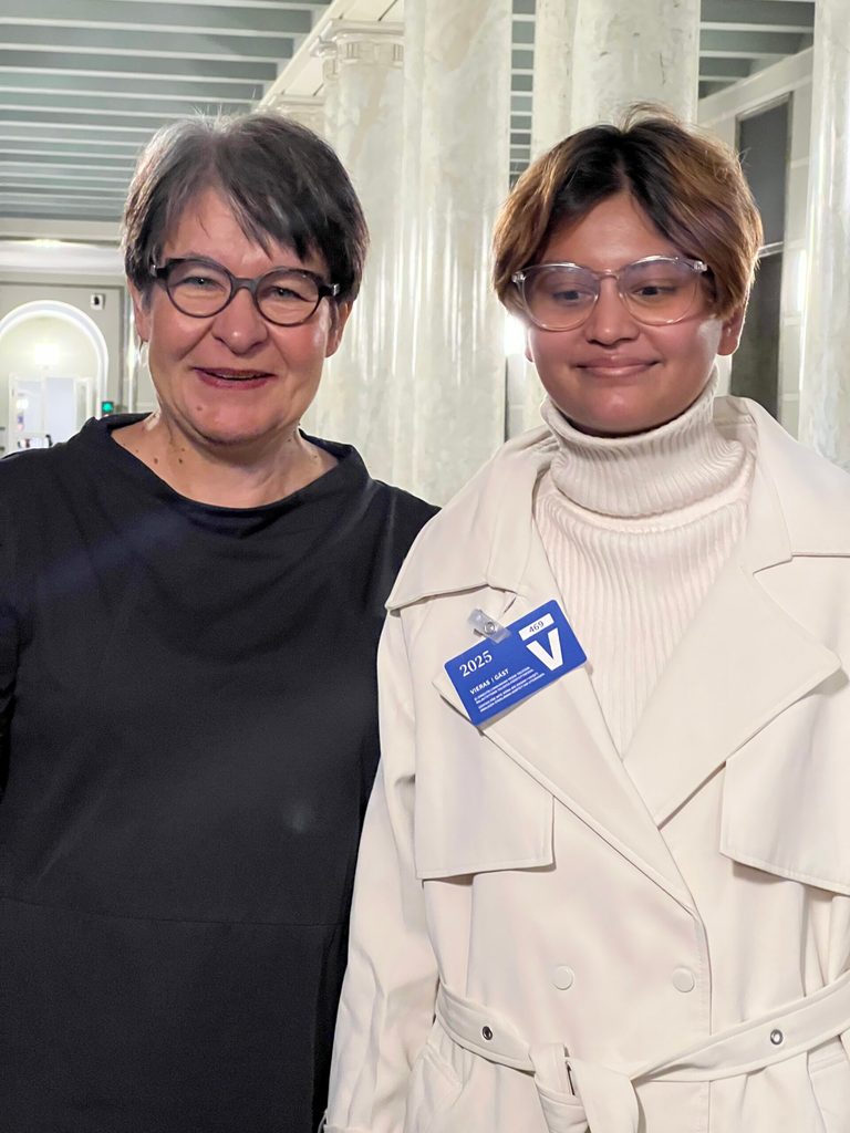 Smarika wearing white coat on right and Second Deputy Speaker Tarja Filatov on left.