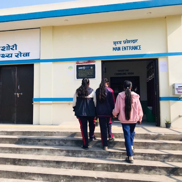 Mira with her friends going to the health facility.