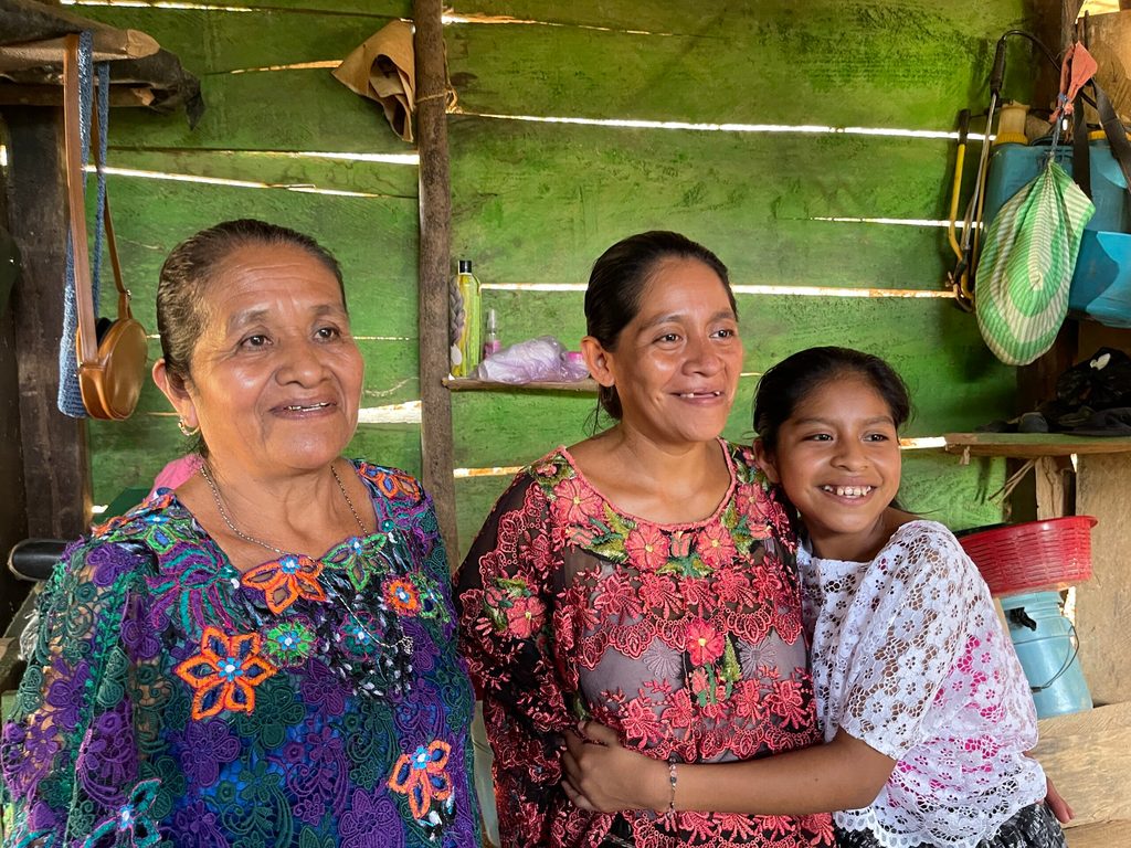 Raquel junto a su mamá y su abuela, posando las tres frente a la cámara.