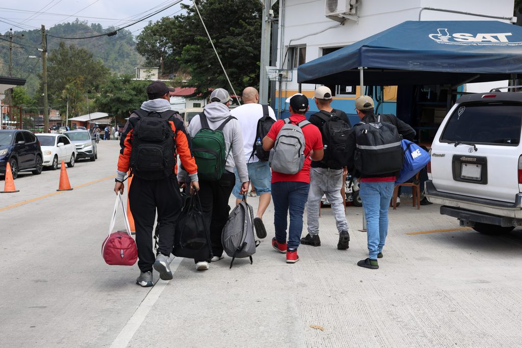 Grupo de hombres en situación de movilidad humana caminando durante su trayecto