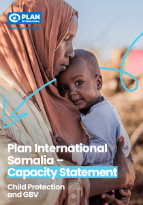 Women holding her son at the IDP camp