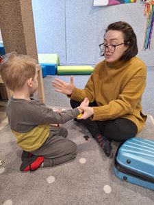 A woman playing with a boy.