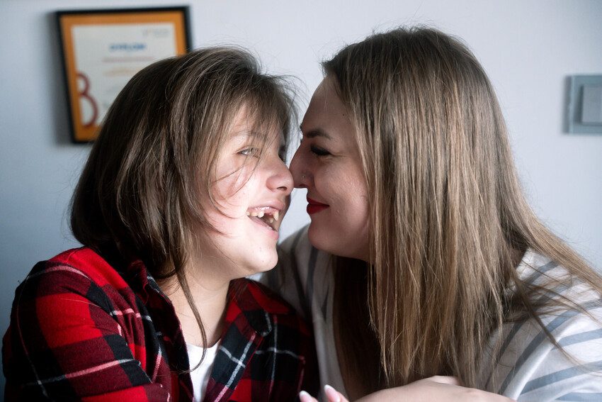 Alesia and her mother Nataliia smiling at each other. 