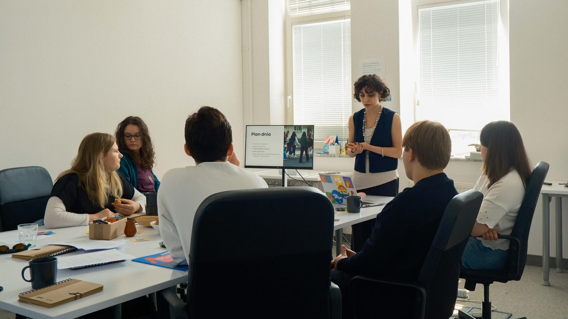 Group of people sitting at a table, discussing.