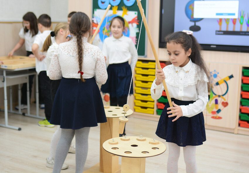 A girl plays with an educational toy. 