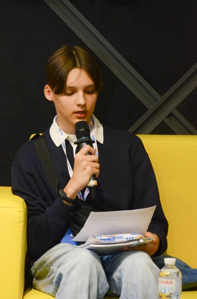 A boy speaking into a microphone